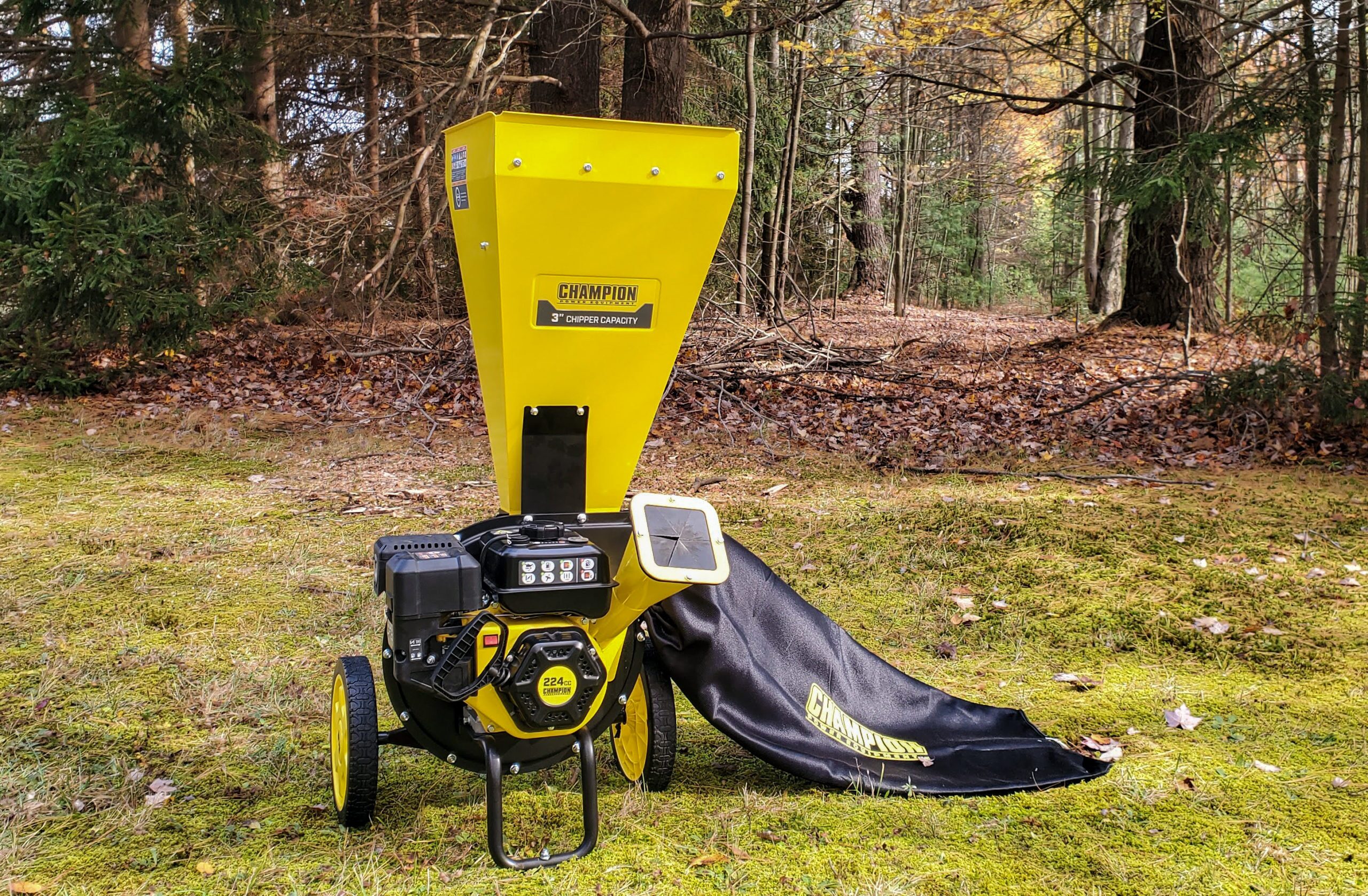 a yellow machine sitting on top of a lush green field.